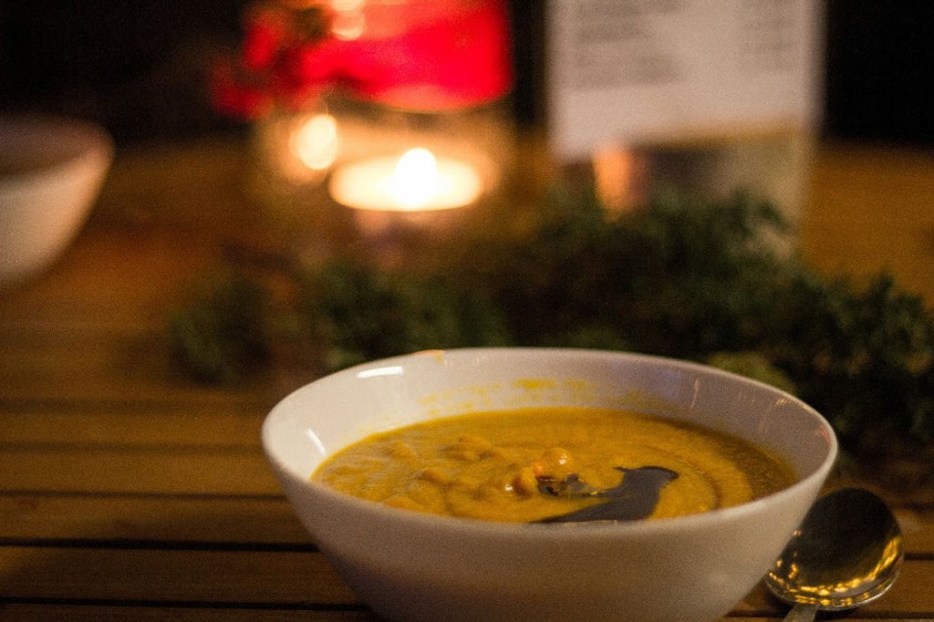 Kürbissuppe bei Kerzenschein an einem gemütlichen Abend