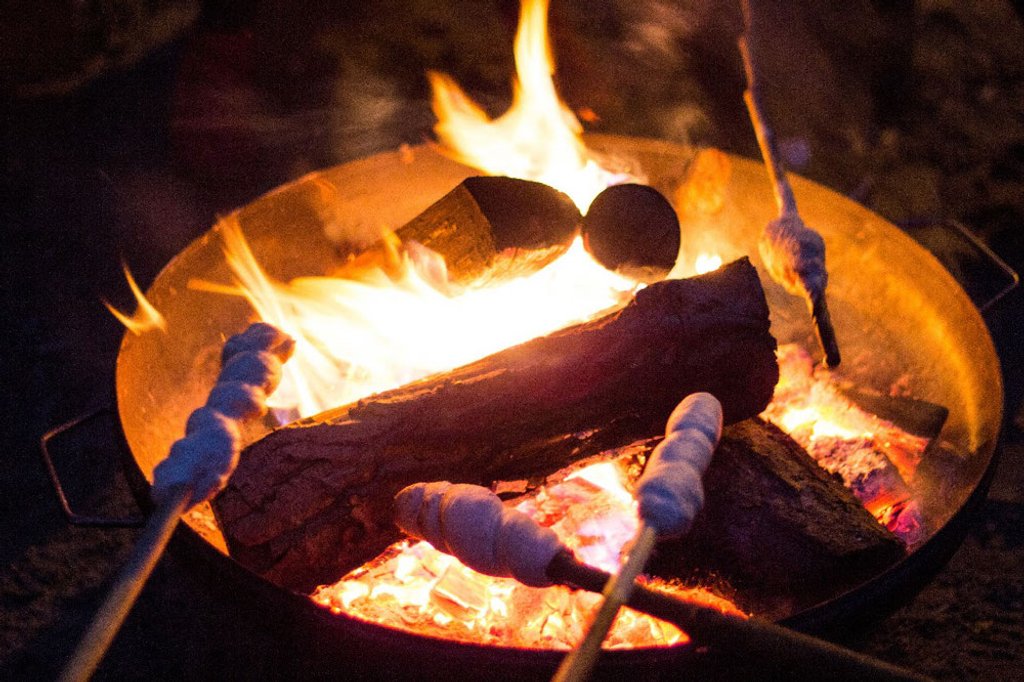 Nahaufnahme von Stockbrot über loderndem Lagerfeuer